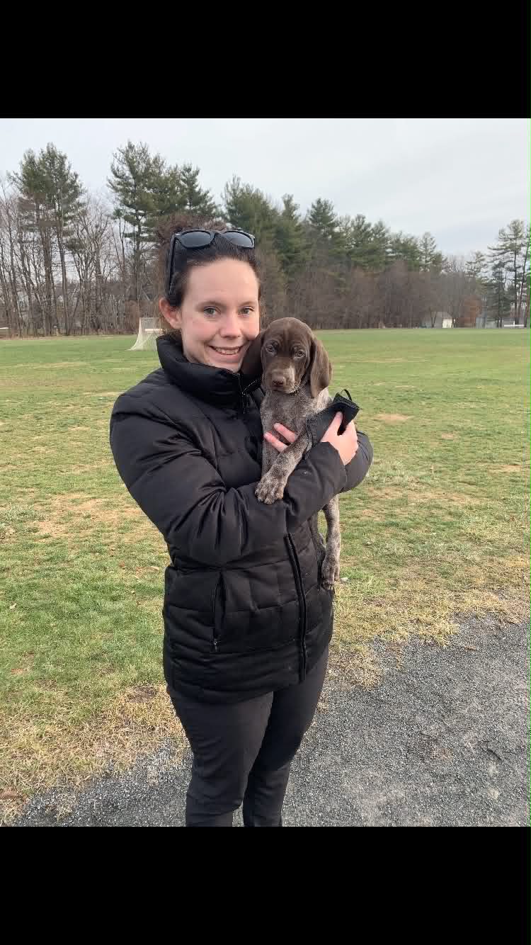 Cassie holding a puppy during puppy training