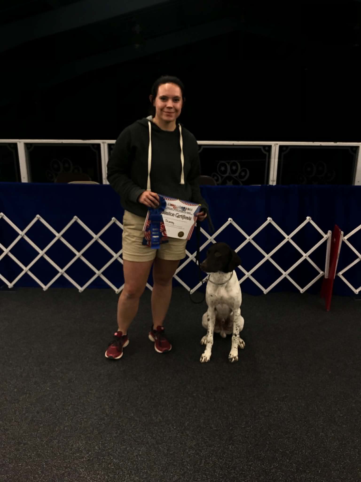 Cassie Kendall with a dog and award ribbon